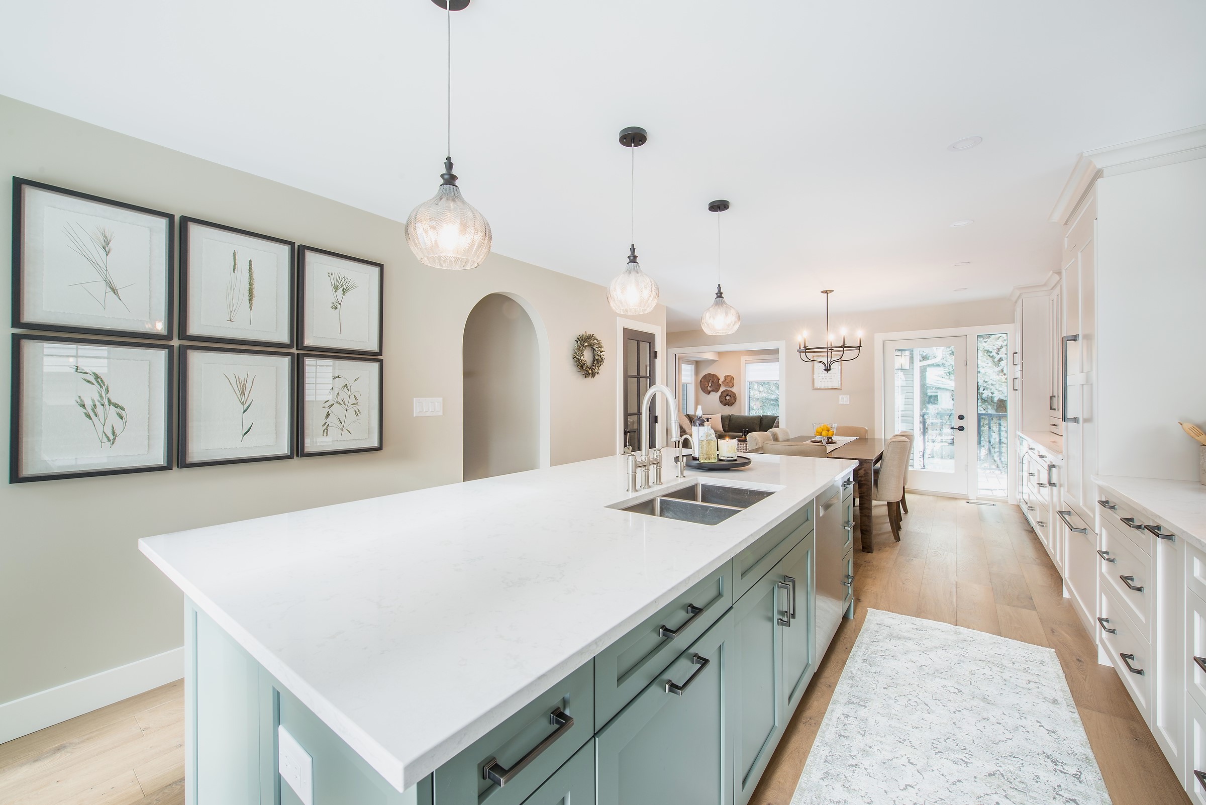 Kitchen renovation with sage green island. Interior decoration and furnishings by Edmonton Interior decorator Sovereign Style Interiors