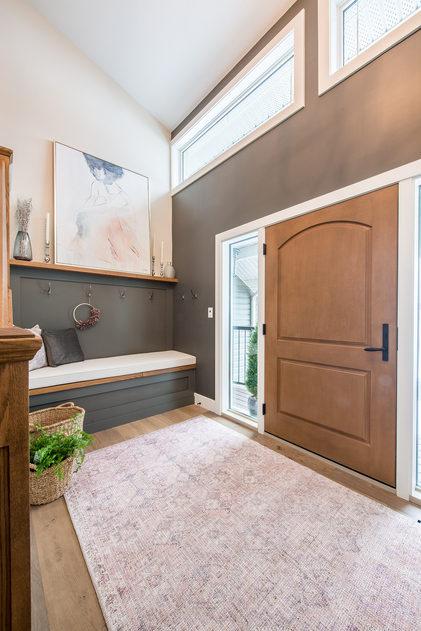 Beautiful front entry with bench seating. Dark wall paint by Sherwin Williams color Iron Ore