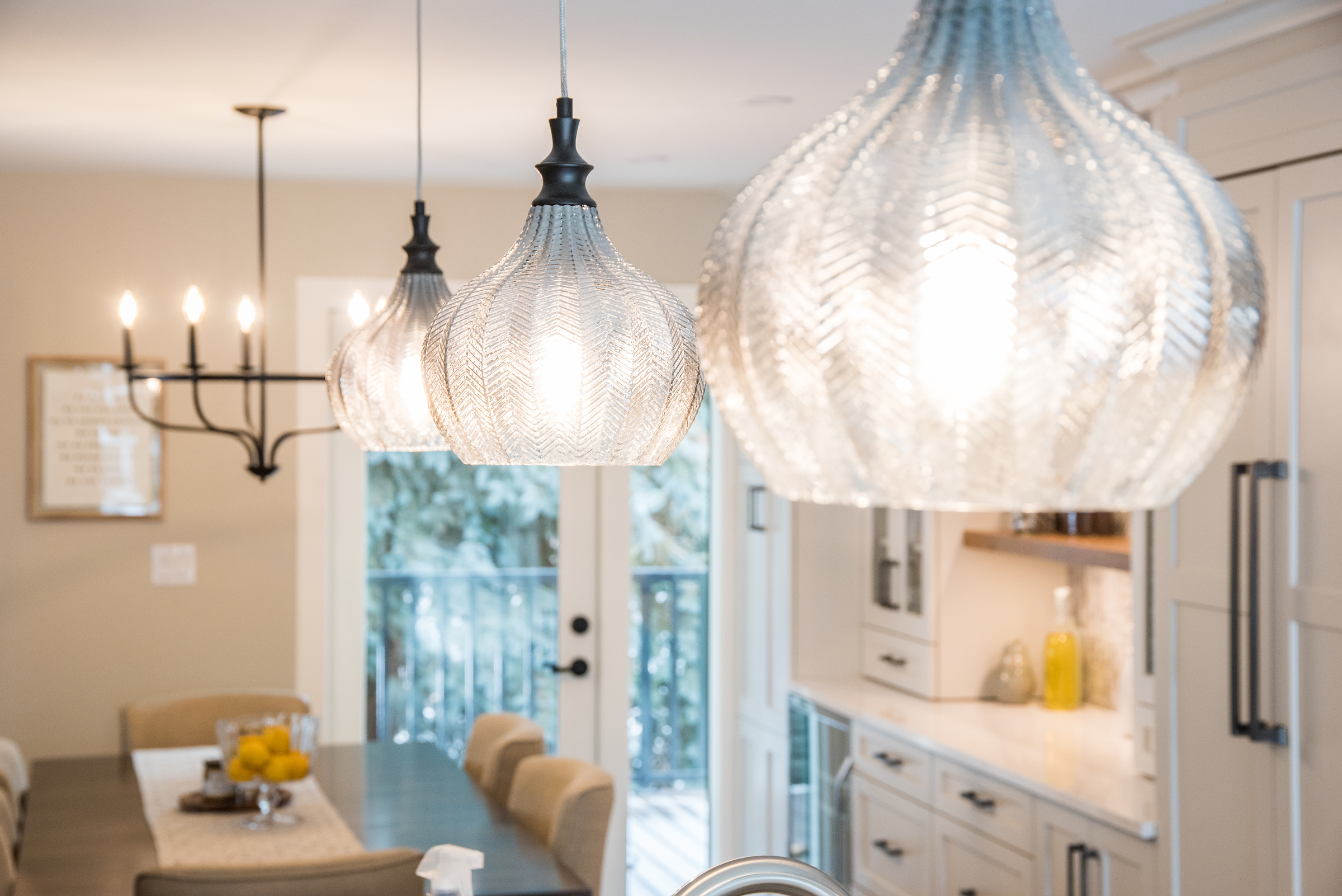 Glass Island pendant lighting set of 3 in kitchen. An Edmonton home and kitchen renovation