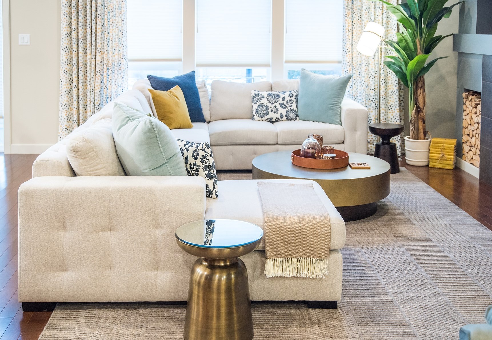 Neutral colored couch with vibrant colored pillows and drapes. Interior decoration of an Edmonton home