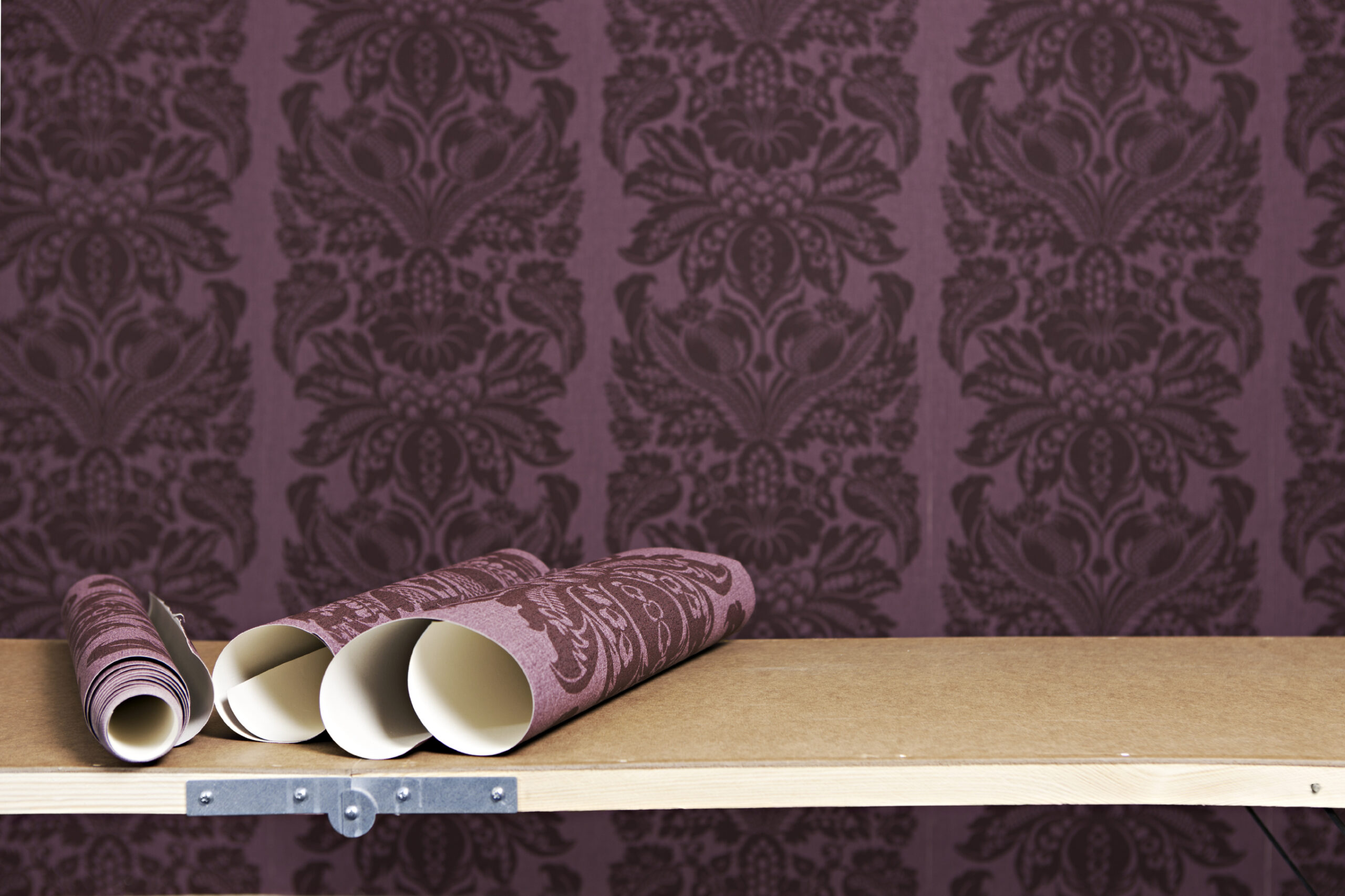 Rolls of wallpaper for interior decoration of a room. Wallpaper or paint options
