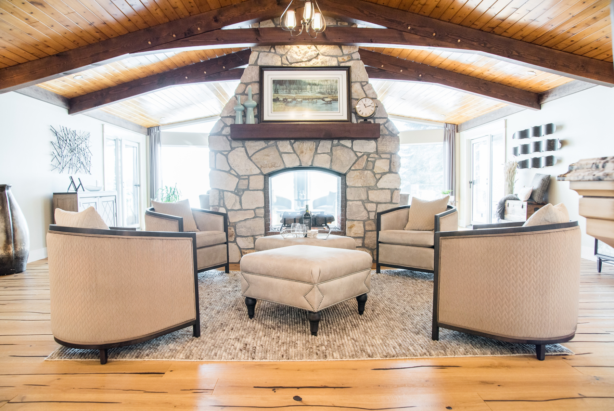 Custom furniture for a beautiful lake house. Sitting area with ottomans and chairs